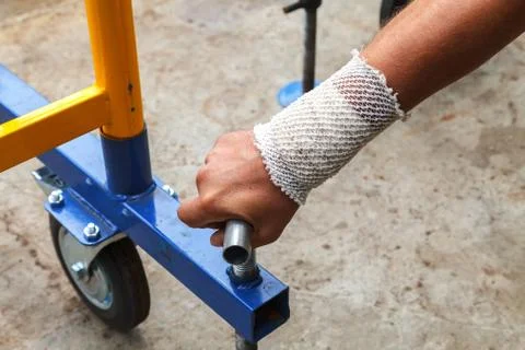 Worker with bandaged hand at work Fotos de archivo