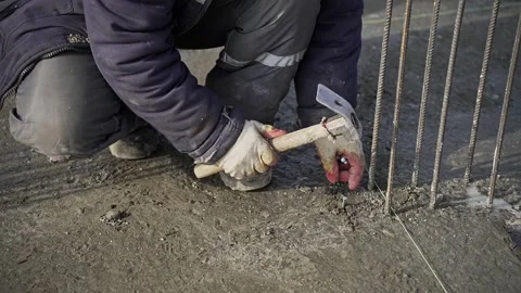 Worker banging with hand hammer at construction site Stock Footage 276682984
