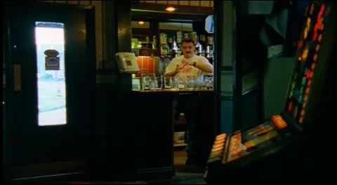 Worker at bar cleaning glasses after customers that left for football match Stock Footage 159443338