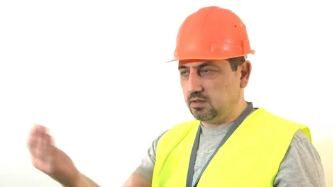Worker with a beard and in a helmet giving a signal Stock Footage 93306758