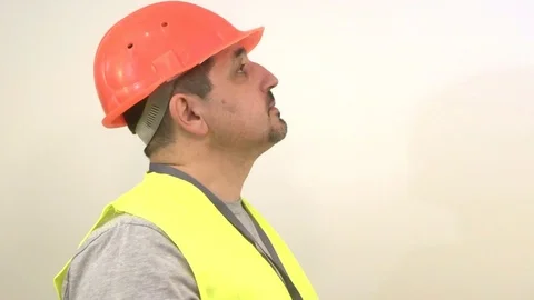 The worker with a beard and in a helmet shows the signal OK Stock Footage 93304183