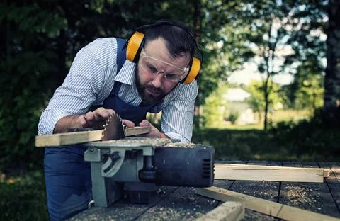 Worker beard man with circular saw desktop items, and the process of prepa... Stock Photos