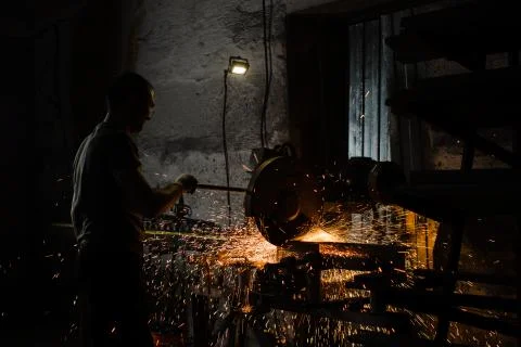 The worker behind the welding arc machine works with metal Stock Photos