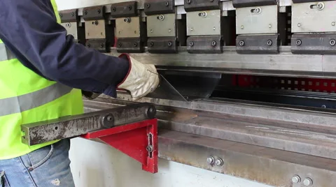 Worker bend metal plate on big machine Stock Footage 60421111