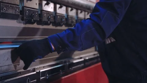 Worker bend metal sheet on a modern bending industrial machine at a factory. Cnc Stock Footage 73471030