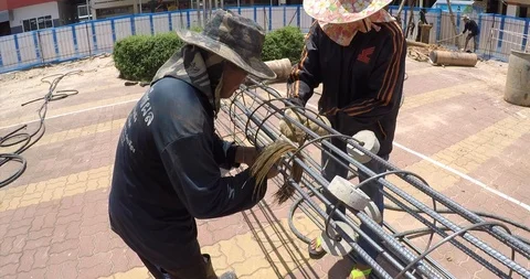 Worker bending and bundle steel for construction job Stock Footage 91877912
