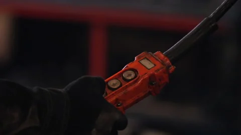 Worker in black gloves presses buttons on control panel Stockbeeldmateriaal 101045909