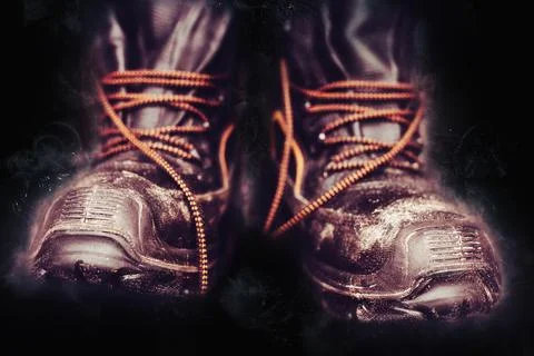 Worker boots on black background Concept of hard work Industry and manifactur Stock Photos