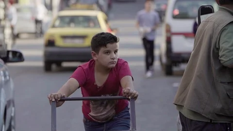 A worker boy pulls a cart in Bloudan, Syria Stock Footage 121807638