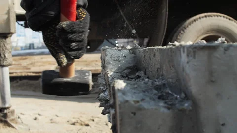 Worker breaking concrete block with hammer Stock Footage 310950576