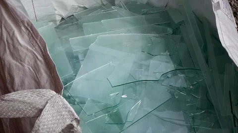 Worker breaking glass waste sheets in to small pieces Stock Footage 105703545