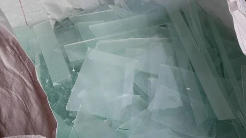 Worker breaking glass waste sheets in to small pieces Stock Footage 105703571