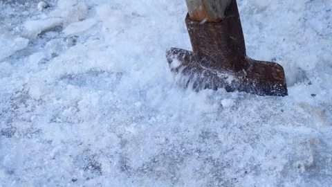 Worker breaking the ice in the front of a small workshop. Stock Footage 85546389