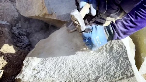Worker Breaking Solid Rock Using Traditional Hand Tools Stock Footage 339531249