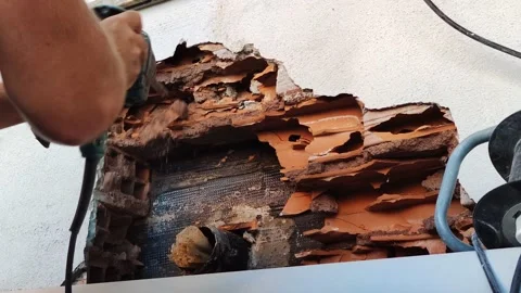 Worker breaks concrete at a construction site. Powerful hammer drill breaks Stock Footage 221564861