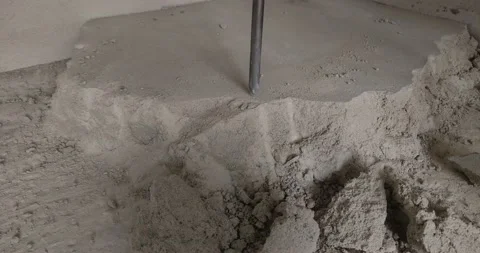 Worker breaks the concrete floor with a hammer drill Video stock 157591181
