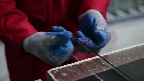 Worker breaks glass after cutting. The shop for the production of double-glazed  Stock Footage 100877905