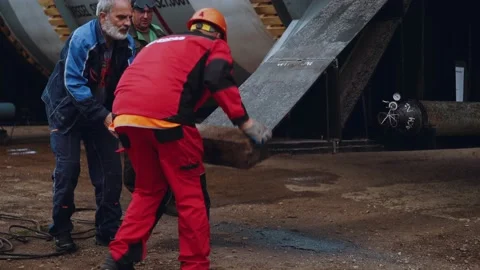 The worker breaks off the metal after cutting by welding Stock Footage 196819097