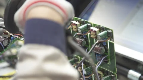 Worker breaks off a piece of the circuit board and scans it. Stock Footage 252644964