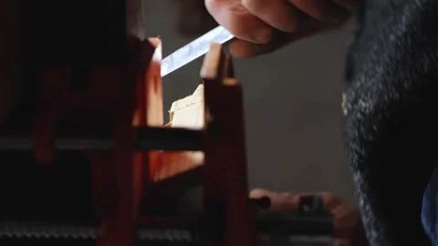 Worker breaks a piece of wood from a piece of wood with a knife and hammer Stock Footage 147872791