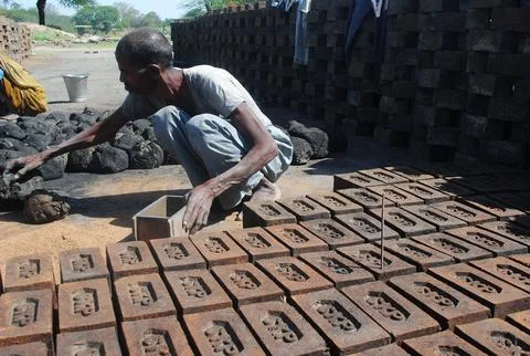 Worker at brick factory  Stock Photos