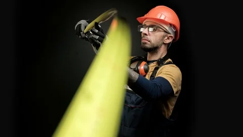 Worker, builder, engineer measures using a measuring tape. Focus shift on Stock Footage 98996959