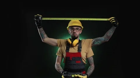 Worker, builder, engineer measures using a measuring tape. Focus shift on Stock Footage 99212159