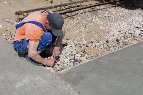 A worker builder sets a direction line for the construction of the formwork b Stock Photos