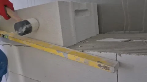 Worker building aerated concrete block wall front view Stock Footage 335298738