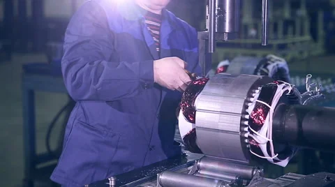 A worker building and testing electric engine in a electronics factory Stock Footage 62479896