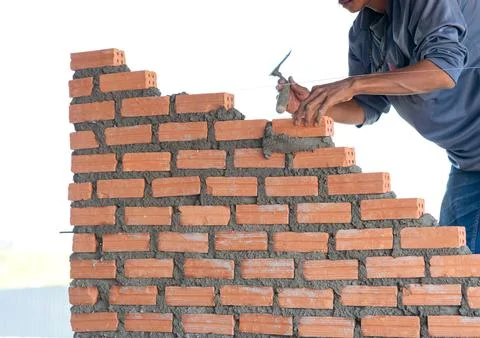 Worker building masonry bathroom wall Stock Photos