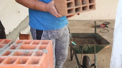 Worker is building a wall with brick and cement Stock Footage 75771107
