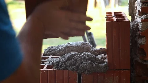 Worker is building the wall with brick and cement brickwork Stock Footage 75771328