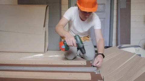 A worker builds a bed in the bedroom Video stock 142158428