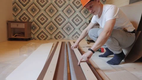 A worker builds a bed in the bedroom 스톡 동영상 143256913