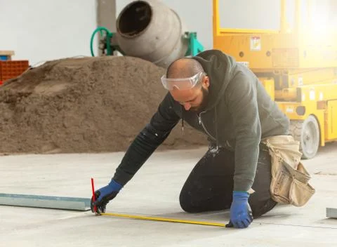 Worker builds a plasterboard wall. Stock Photos