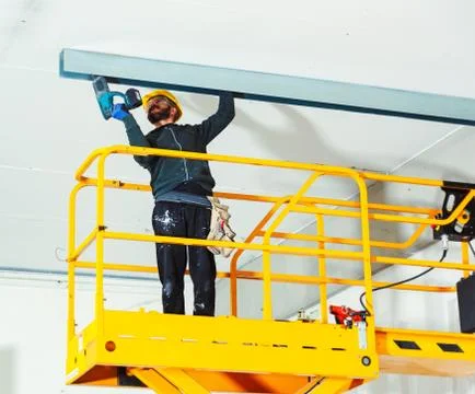 Worker builds a plasterboard wall. Stock Photos
