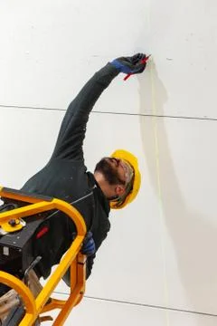 Worker builds a plasterboard wall. Stock Photos