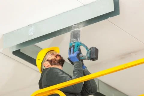 Worker builds a plasterboard wall. Stock Photos