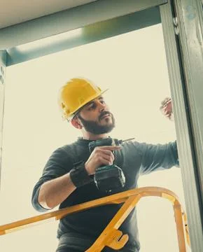 Worker builds a plasterboard wall. Stock Photos