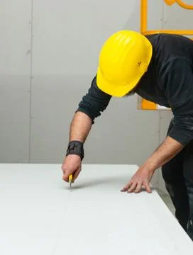 Worker builds a plasterboard wall. Stock Photos
