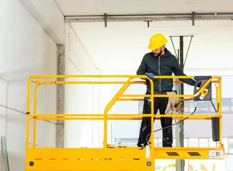 Worker builds a plasterboard wall. Stock Photos