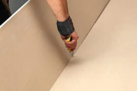 Worker builds a plasterboard wall. Stock Photos