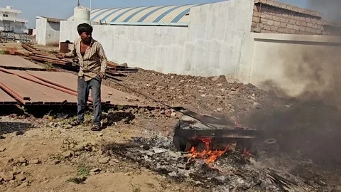Worker is burning the casting west in outside of factory Video stock 305996871