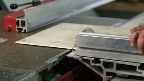 Worker carefully operates a table saw Stock Footage 327014609