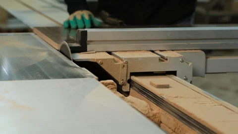 Worker carefully operates a table saw Stock Footage 327015513