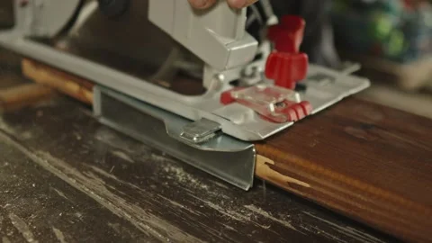 Worker carpenter is sawing a wooden Board with a hand-held circular saw Stock Footage 283473448