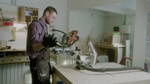 Worker at carpenter workspace cutting the edge of wood board using fret saw Stock Footage 151273954
