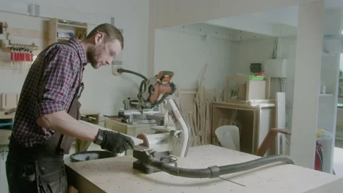 Worker at carpenter workspace cutting the edge of wood board using fret saw Stock Footage 151274258