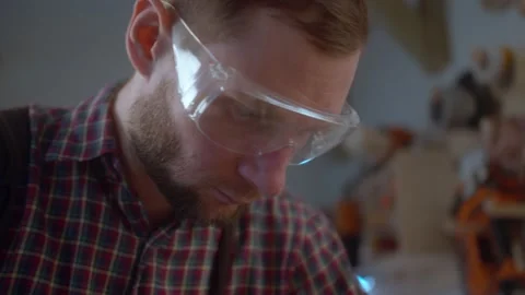 Worker at carpenter workspace cutting the edge of wood board using fret saw Stock Footage 151274270